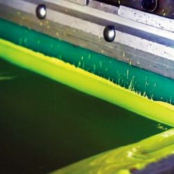 How is a squeegee used in the silkscreen process